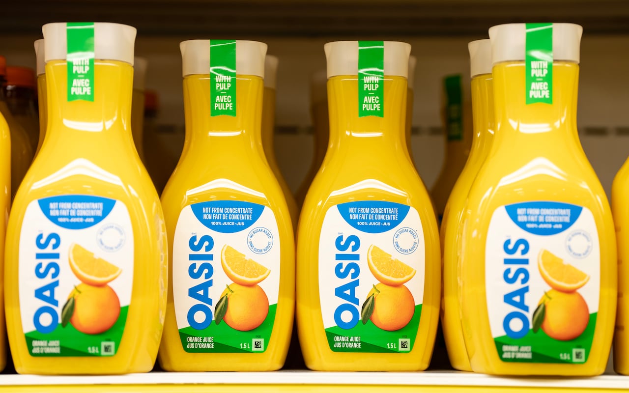 Cartons of orange juice on a shelf, the labels says Oasis