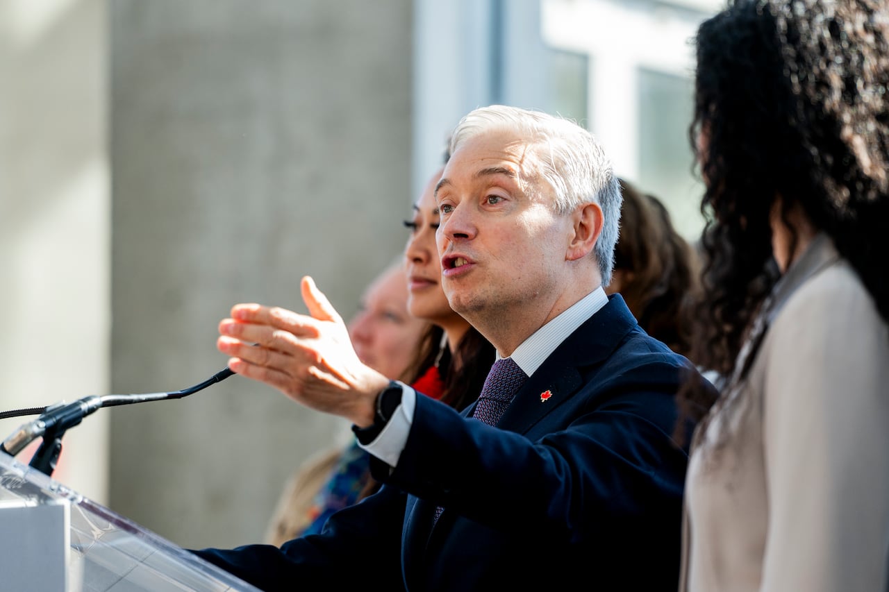 Minister of Finance and National Revenue Francois-Philippe Champagne speaks at a press conference podium.