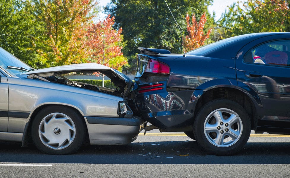 Minor accident with one car rear-ending another.