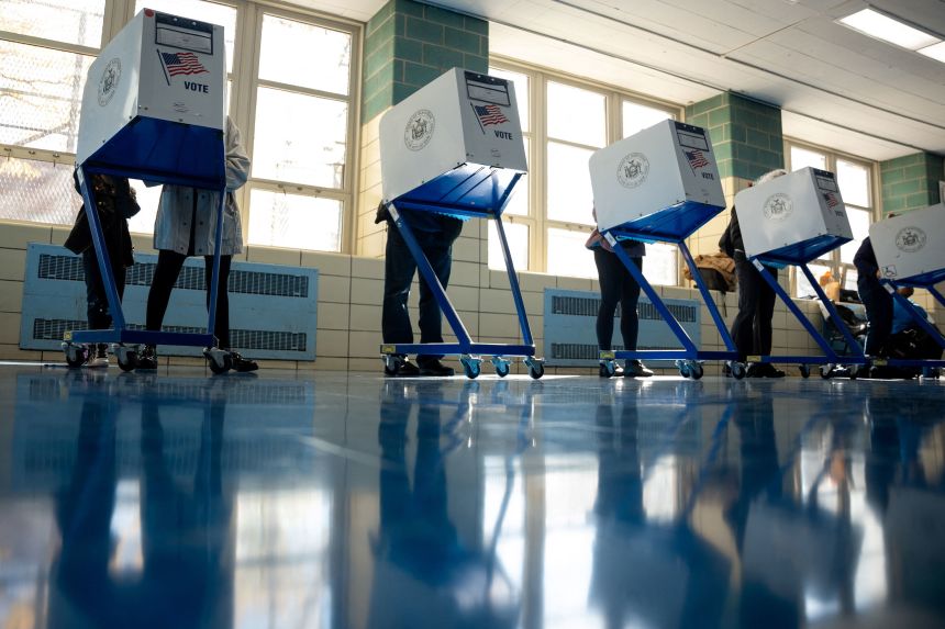 Voters fill out their ballots at a polling site New York on Tuesday.
