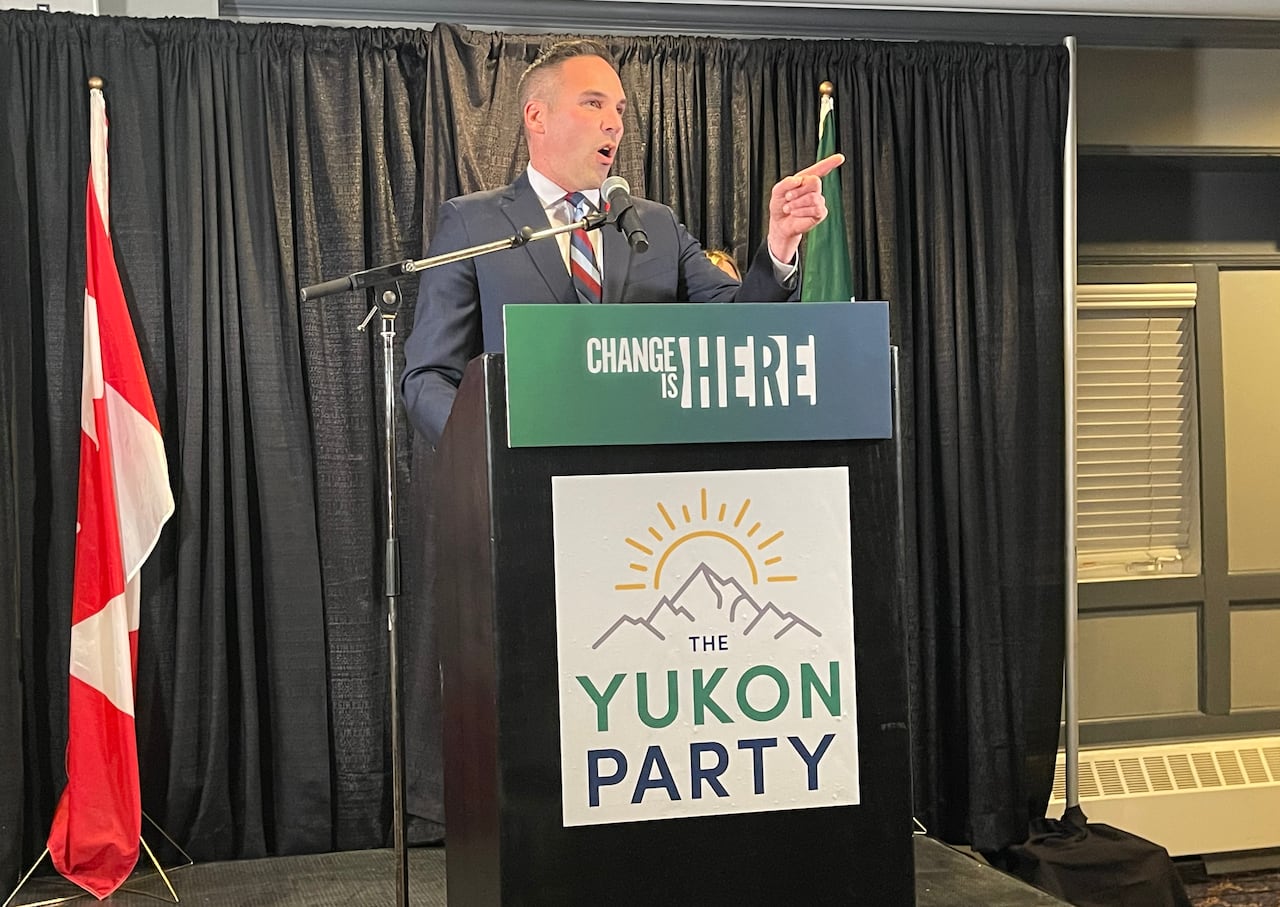 A man speaks from behind a podium.