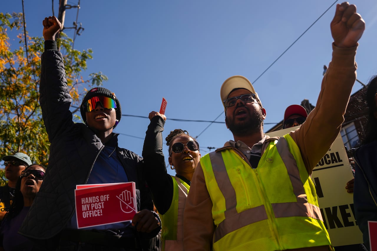 Protesters hold up their fists.