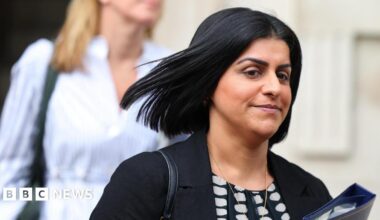Shabana Mahmood, with hair flying in the wind, clutches a blue folder in Downing Street