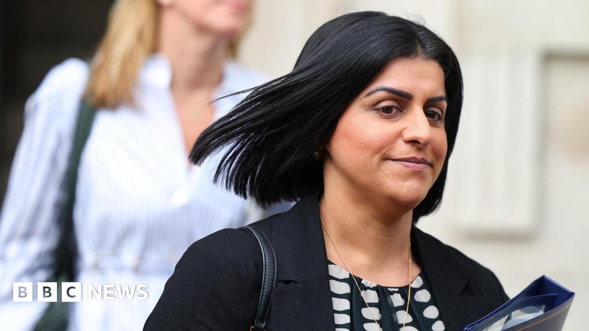 Shabana Mahmood, with hair flying in the wind, clutches a blue folder in Downing Street
