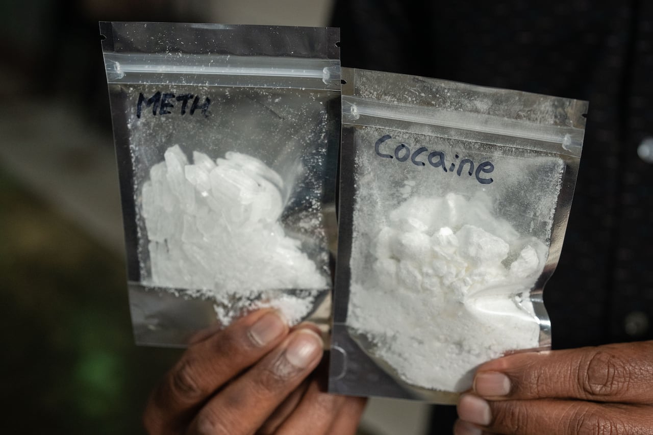 Two baggies of white crystals and powder marked 'Meth' and 'Cocaine'.
