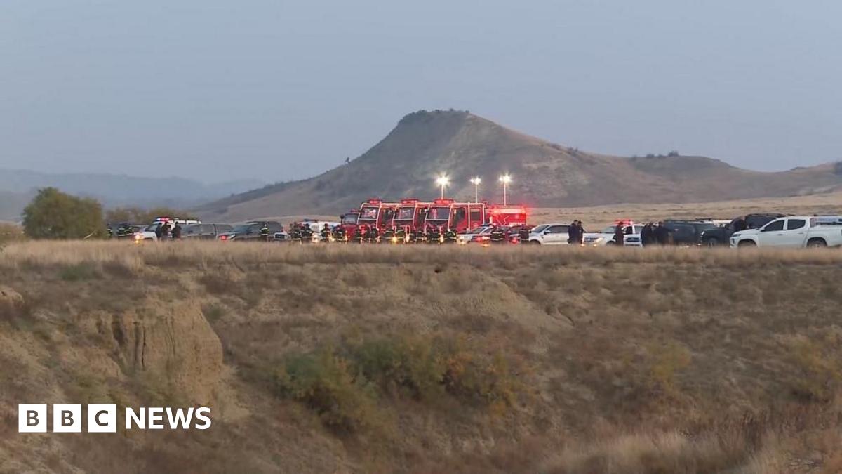 Emergency vehicles including what appears to be police and fire and rescue as photographed from a distance.