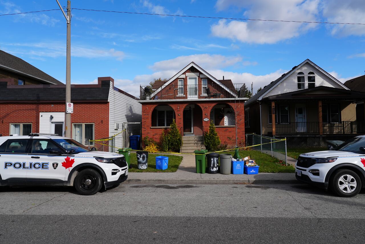 A home with police tape across the front. 
