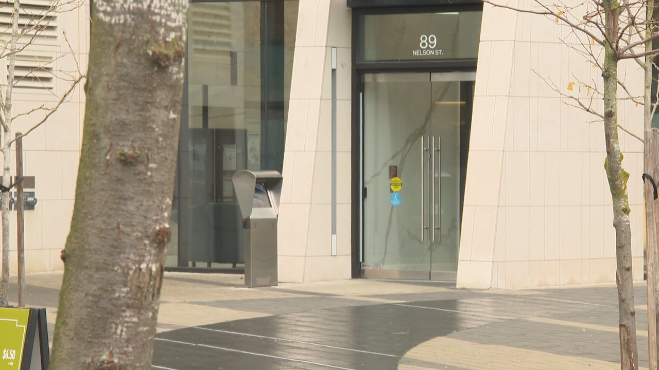 An entrance to an apartment building marked '89 Nelson St.'