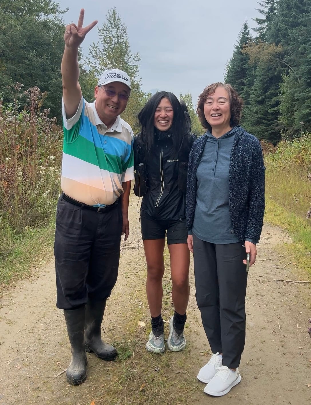 A group of East Asian smile while on a trail.