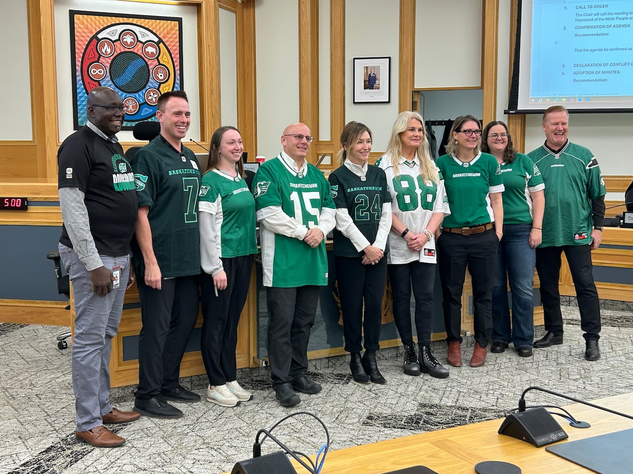 a group of men and women pose in sports jerseys and shirts