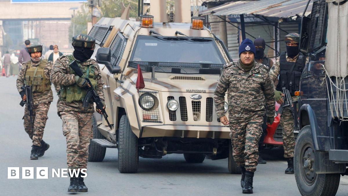 Four members of India's security forces wearing military fatigues arrive outside a police station in Srinagar, Indian Kashmir on 15 November 2025.