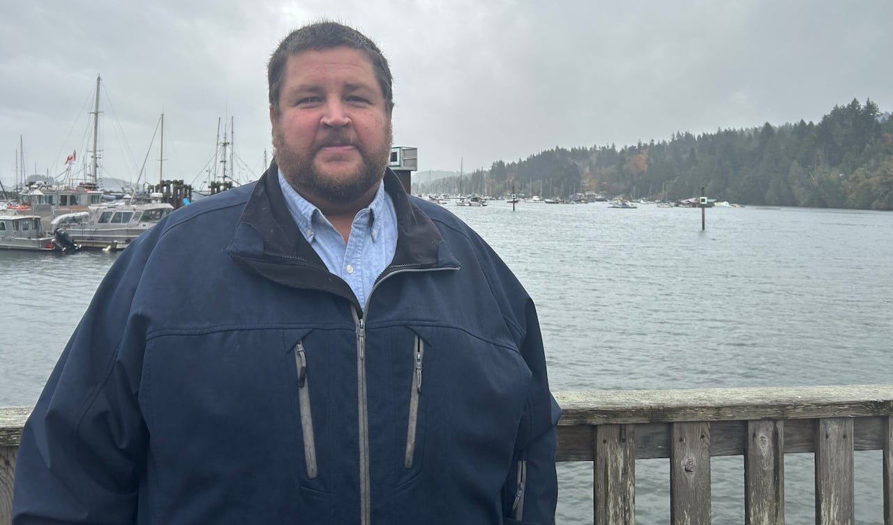 a man stands by a harbour