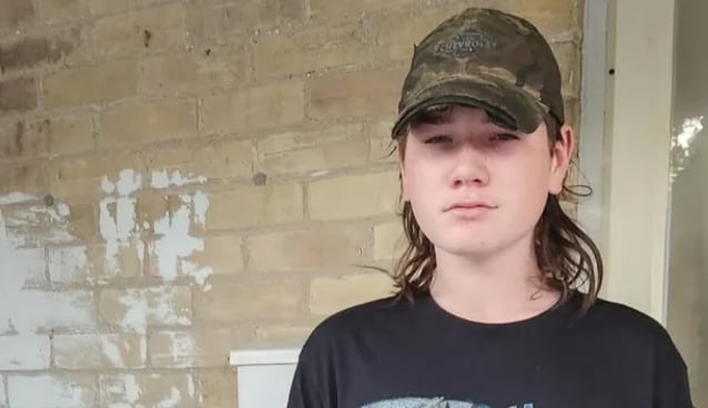 A boy in a camo baseball hat 