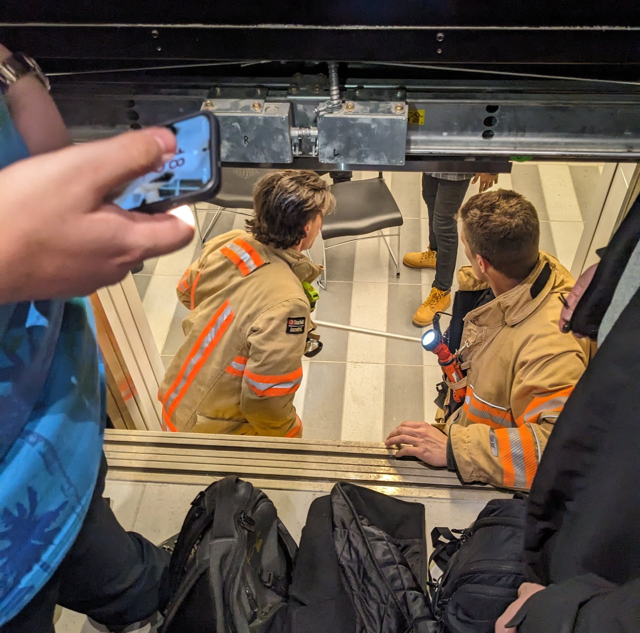 firefighters free people stuck in an elevator