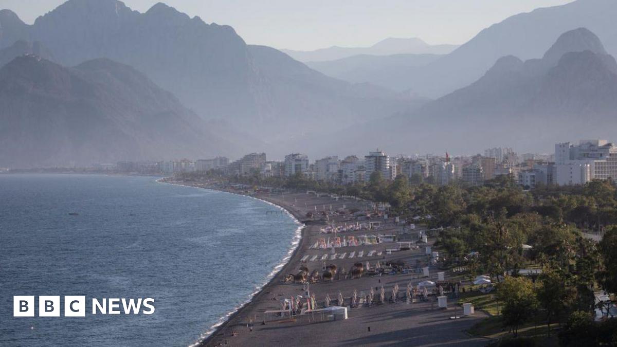 People walk on a near empty Konyaalti beach during a weekend lockdown on 06 June, 2021 in Antalya, Turkey.