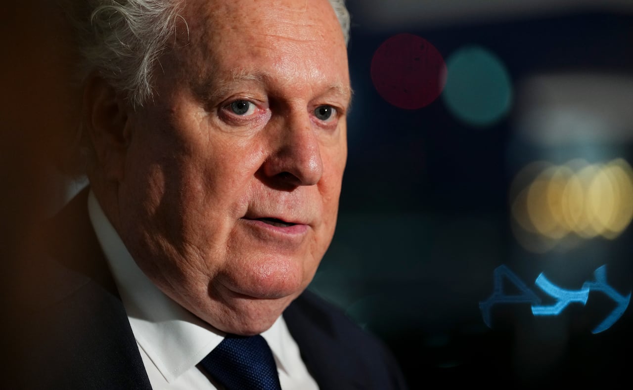 A closeup photo of a man in a suit.