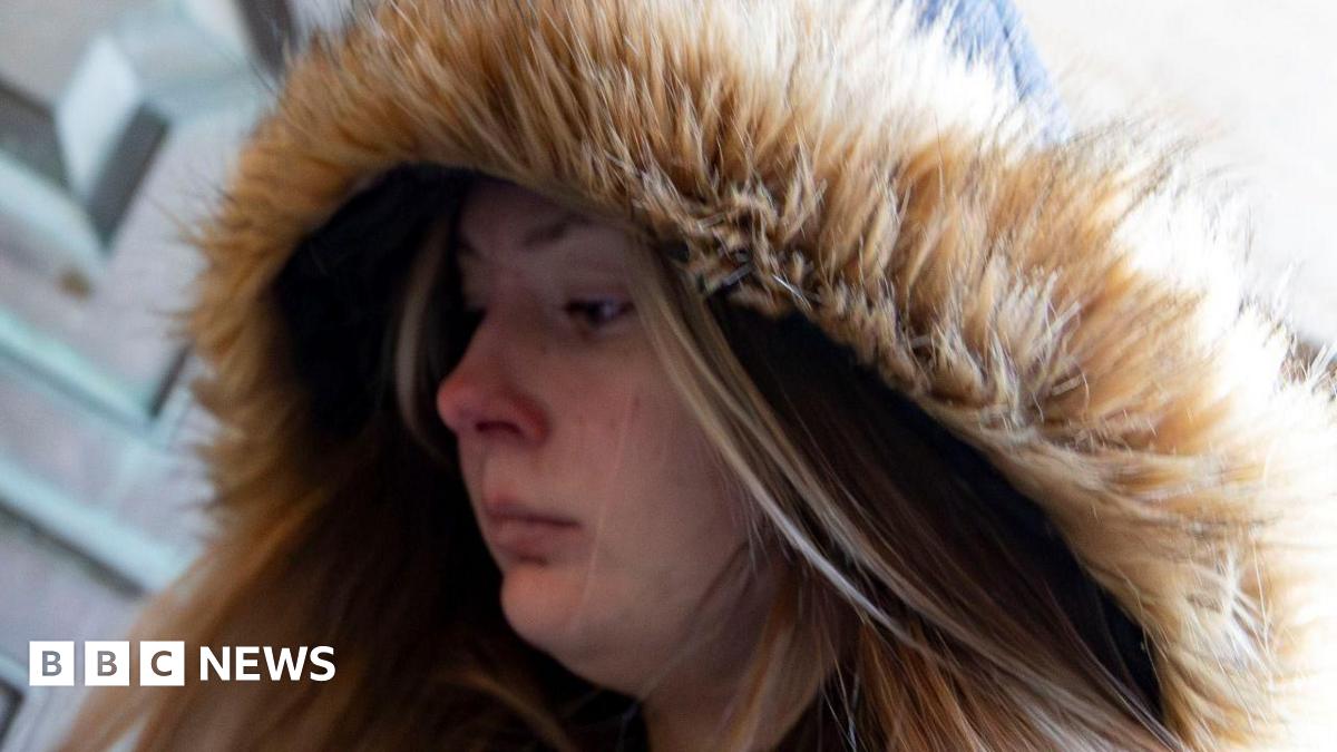 A young woman with a fur-lined hood enters a court building