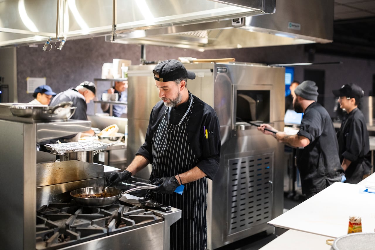 People working in a big kitchen.