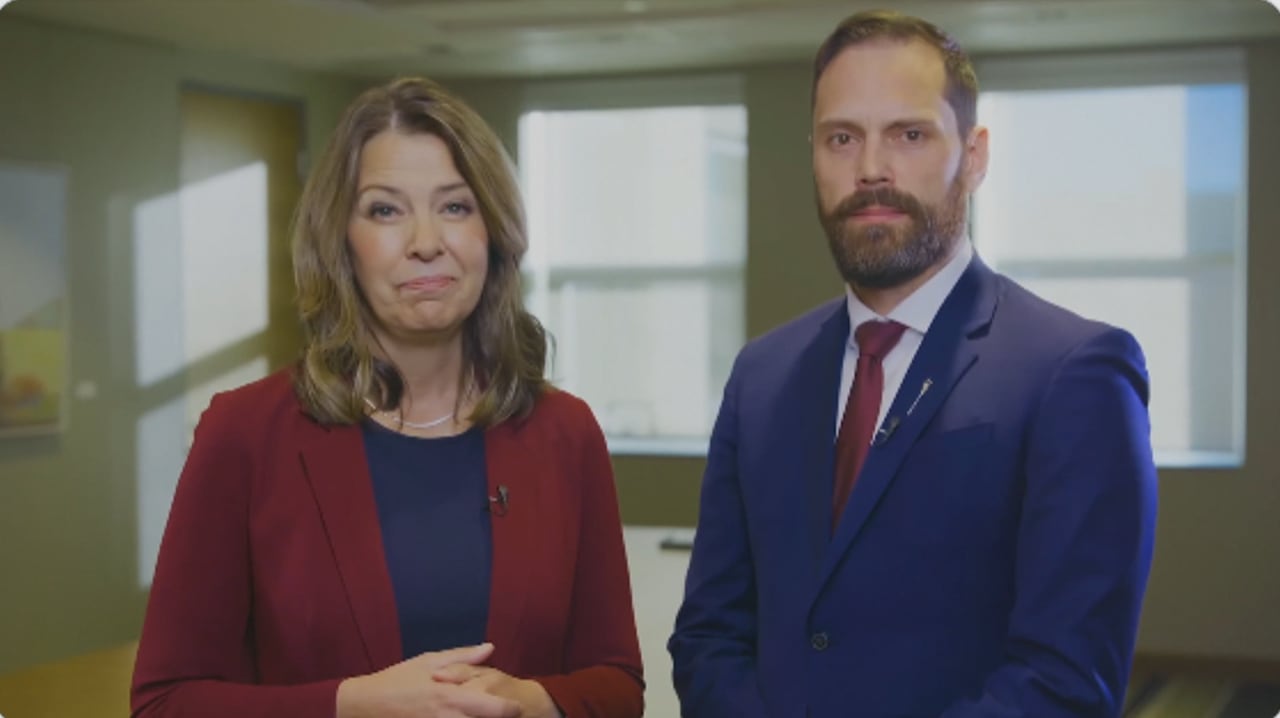 Alberta premier Danielle Smith and Minister Matt Jones stand side by side 