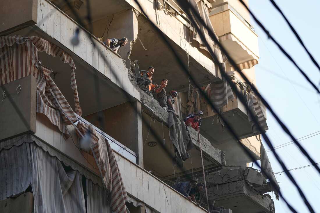 Lebanese Civil Defence workers inspect the damage at an apartment hit during an Israeli airstrike on Dahiyeh in the southern suburb of Beirut, Sunday Nov. 23, 2025.
