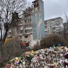 Outside a destroyed apartment building in the western Ukrainian city of Ternopil, local residents have left flowers, candles and stuffed toys to commemorate the dozens, including several children, killed in an overnight Russian attack
