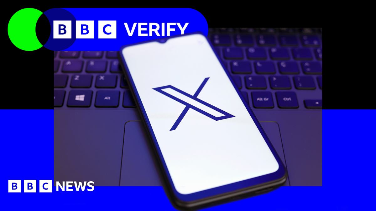 A mobile phone with the 'X' logo next to a laptop keyboard