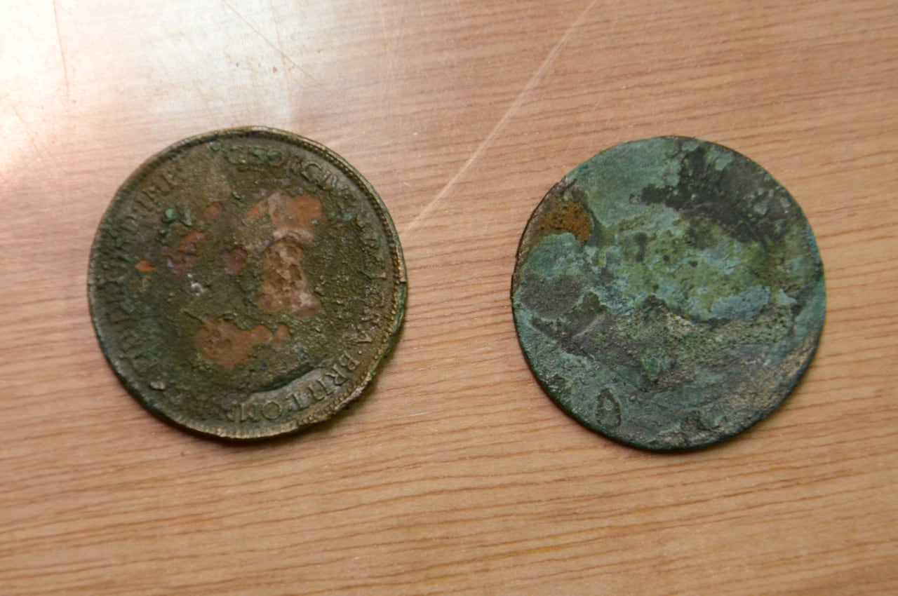old coins found with human remains