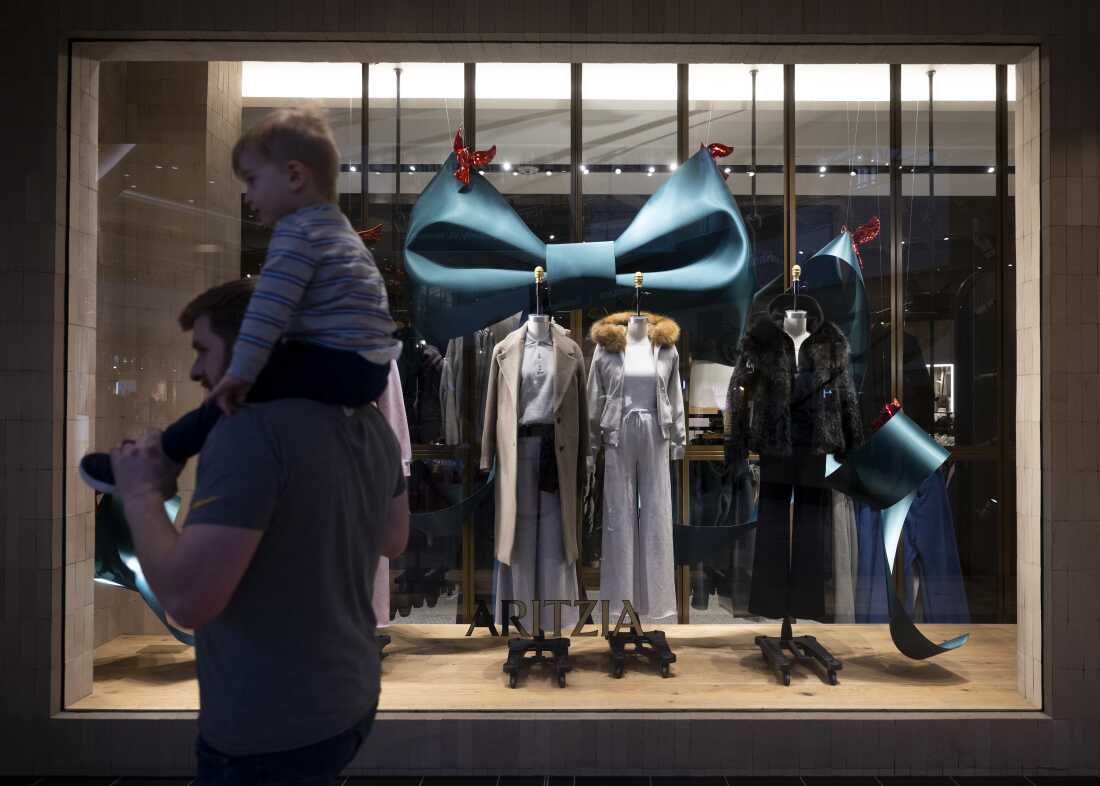 Shoppers walk by clothing items displayed inside the Aritzia store at Ross Park Mall.