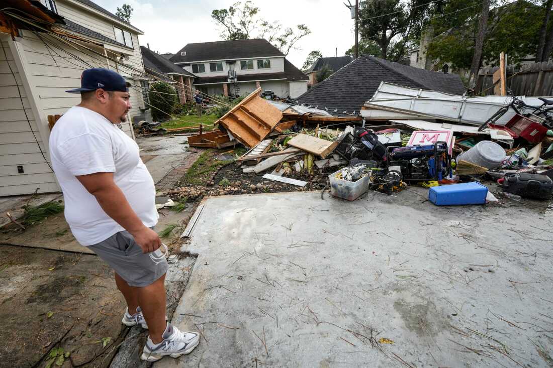 Guillermo Vargas surveys damage to his home, where his garage was swept off its foundation, while cleaning up storm damage after severe weather hit in the Memorial Northwest subdivision, in Spring, Texas, on Monday.