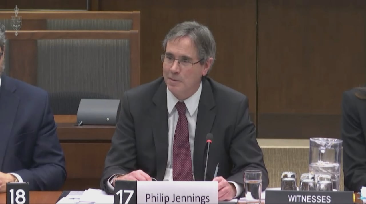 A man in a suit sits at a table