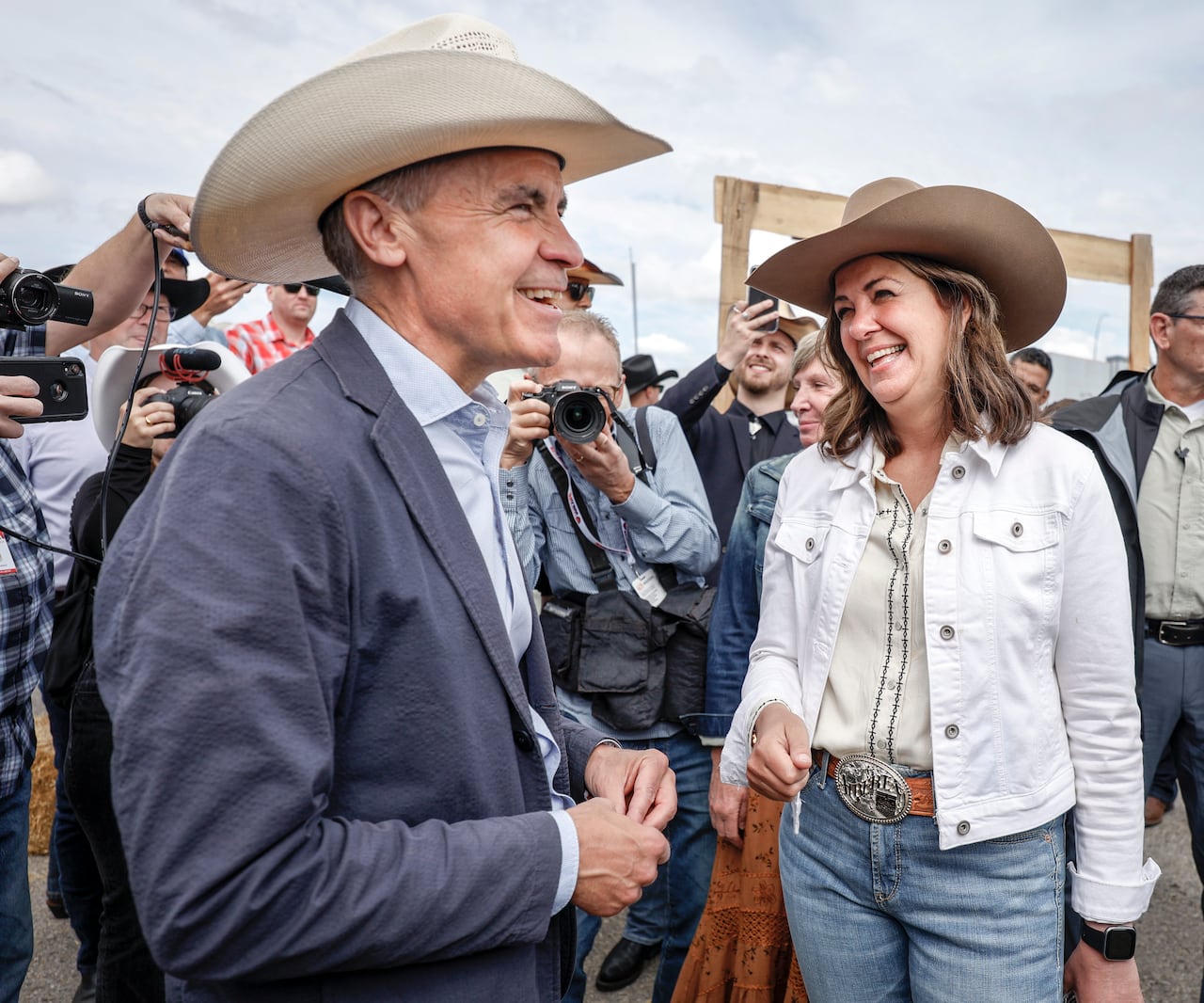 Prime Minister Mark Carney, left, meets with Alberta Premier Danielle Smith as the pair attend a Stampede breakfast in Calgary, Alta., Saturday, July 5, 2025.