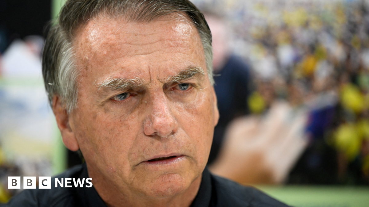 Former Brazilian President Jair Bolsonaro pictured from the neck up during an interview with Reuters in Brasilia, Brazil, on July 18, 2025. He is wearing a dark shirt and has a stern expression.