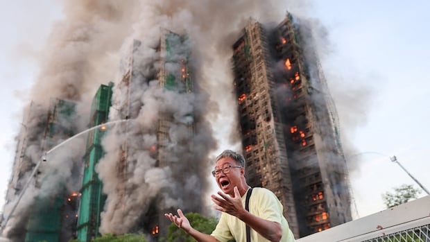 Hong Kong highrise fire leaves at least 13 dead, with reports of residents trapped