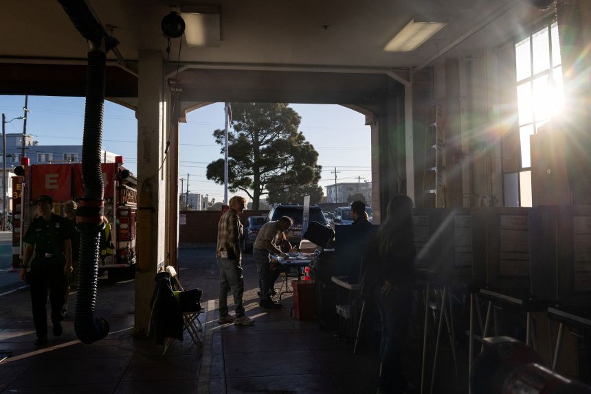 Voters arrive to vote at a polling station in San Francisco, California, on November 4, during California's special election on Proposition 50, a measure that would temporarily redraw congressional districts.