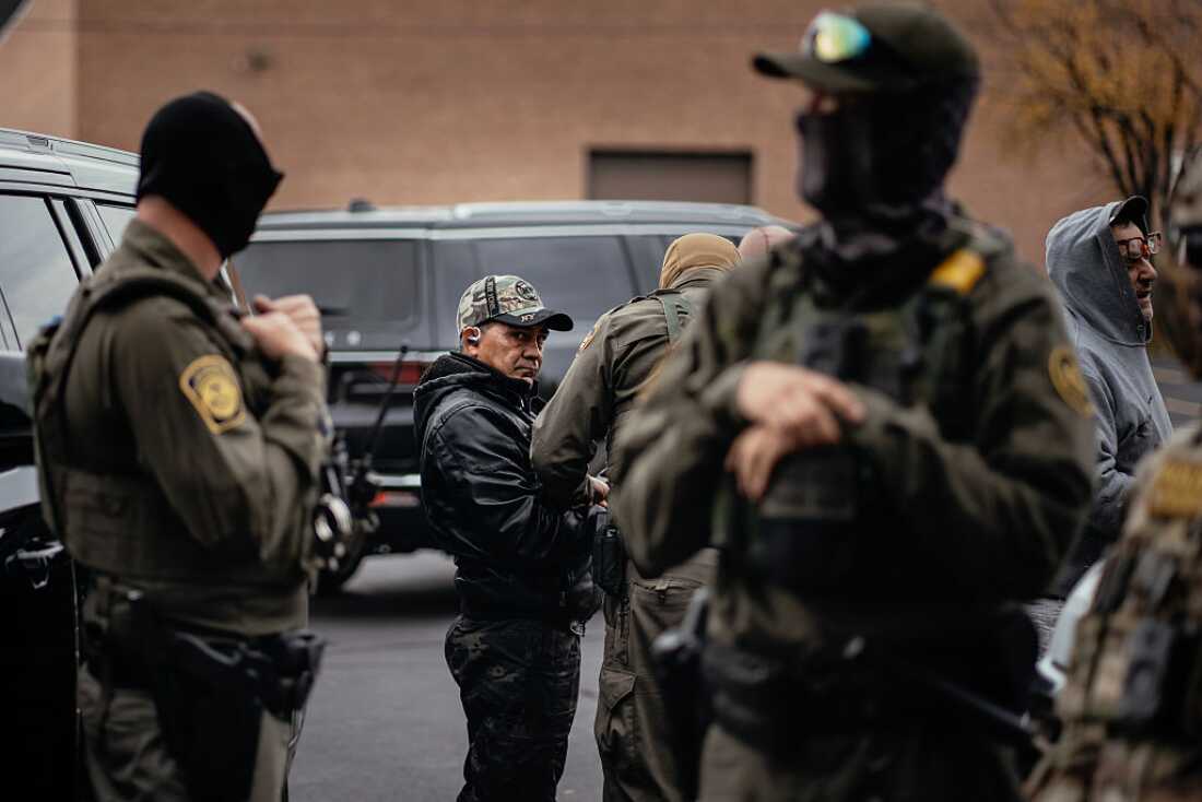 People detained earlier in the day are taken to a parking lot on the far north side of the city before being transferred to an Immigration and Customs Enforcement facility on Oct. 31, 2025, in Chicago, Ill.