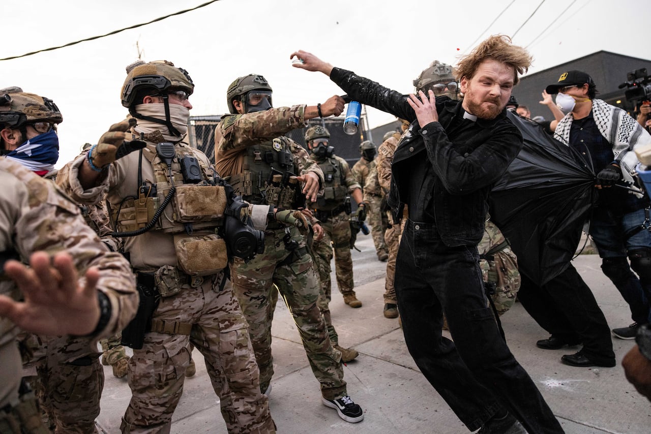 A preacher is pepper-sprayed by officers