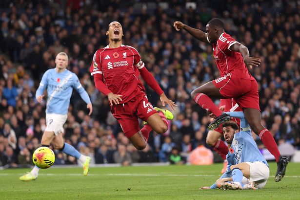 Virgil van Dijk of Liverpool is challenged by Bernardo Silva of Manchester City during the Premier League match at the Etihad Stadium on November 9 2025
