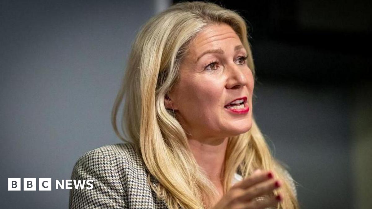 Laura Anne Jones gesturing in front of her.