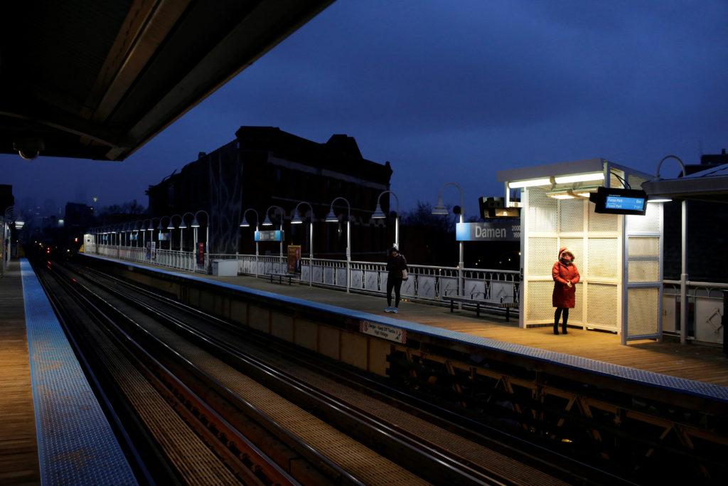 Commuters wait for the Chicago Transit Authority Blue line train in Chicago