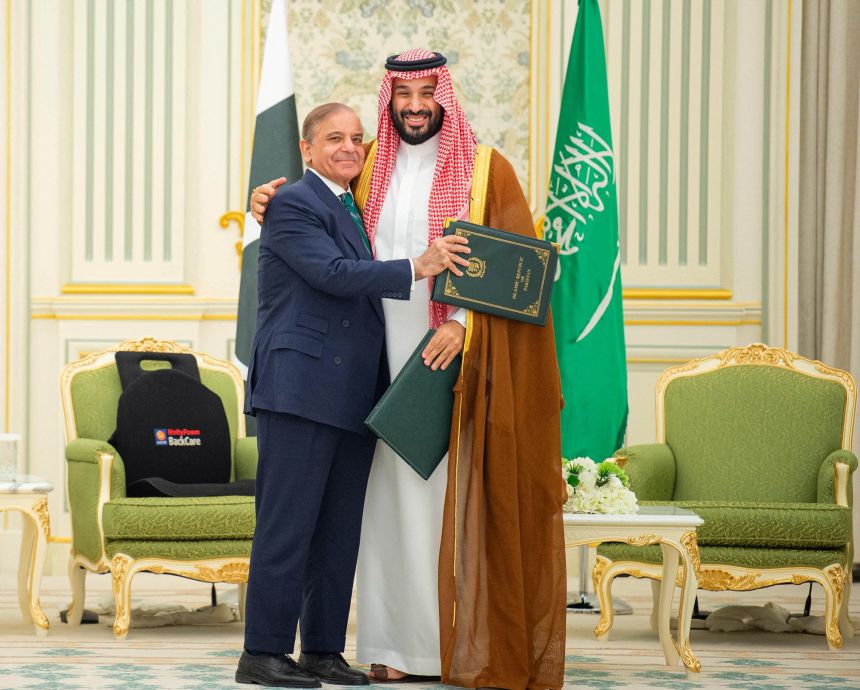 Saudi Crown Prince Mohammed bin Salman and Pakistan Prime Minister Shehbaz Sharif embrace each other on the day they sign a defence agreement, in Riyadh, Saudi Arabia, September 17.