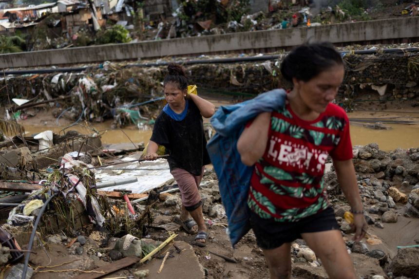 Residents return to the remains of their homes that were swept away in the floods caused by Typhoon Kalmaegi in Talisay, Cebu, Philippines, on November 5, 2025.