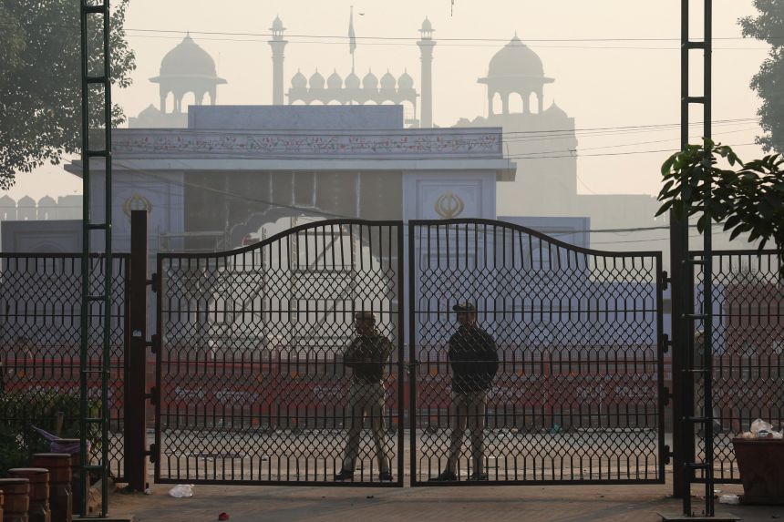 Policemen stand guard at the site of an explosion near the historic Red Fort in the old quarters of Delhi, India, on November 11, 2025.