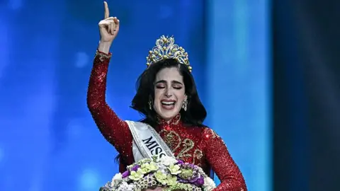 Getty Images Newly-crowned Miss Universe Fatima Bosh from Mexico points to the sky after she is crowned