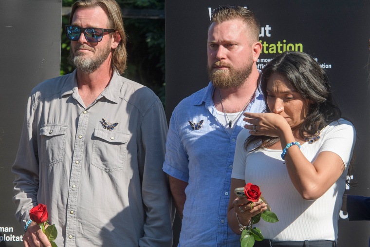Virginia Giuffre's brothers, Daniel Wilson, left, and Sky Roberts, stand with her sister-in-law Amanda Roberts at rally on Capitol Hill on  Sept. 3, 2025.
