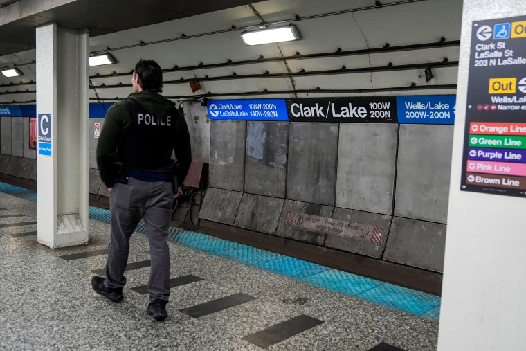 A Chicago police officer patrols the Clark Street and Lake Street Blue Line stop.