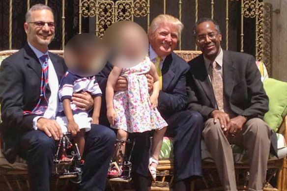 Dror Paley photographed with Donald Trump and Ben Carson in 2013.