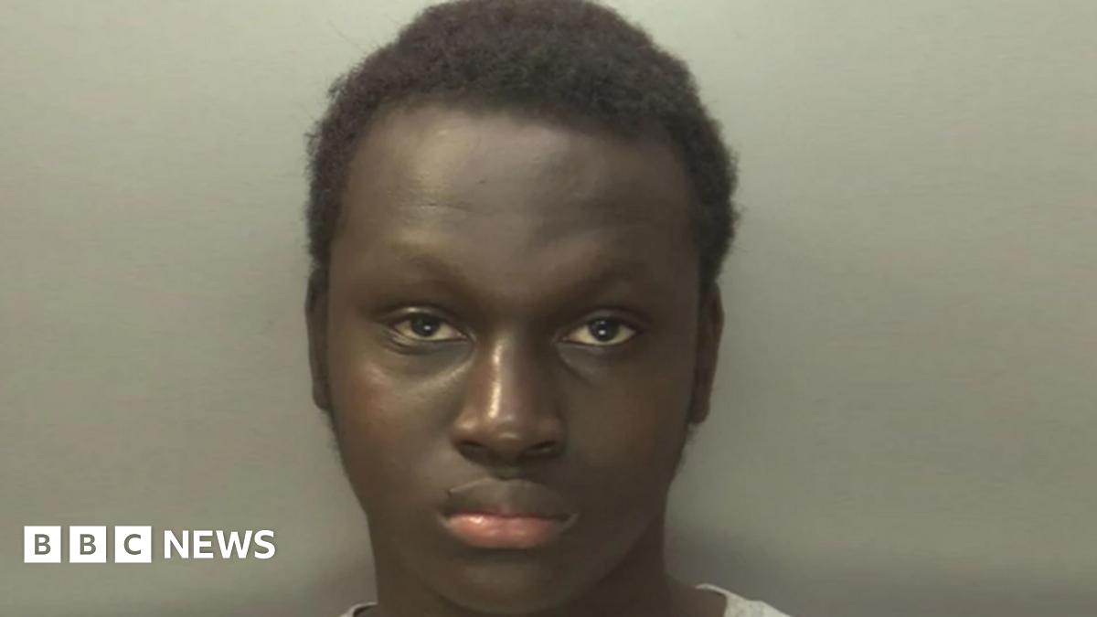 An employee of Severn Trent holds a soiled wet wipe in front of a pile of wet wipes.