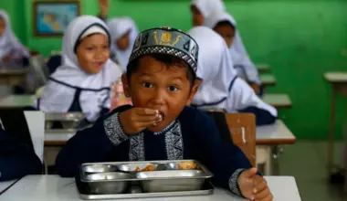 An Indonesian student eats a free meal at an elementary school in Banda Aceh, Indonesia, on Oct 30.