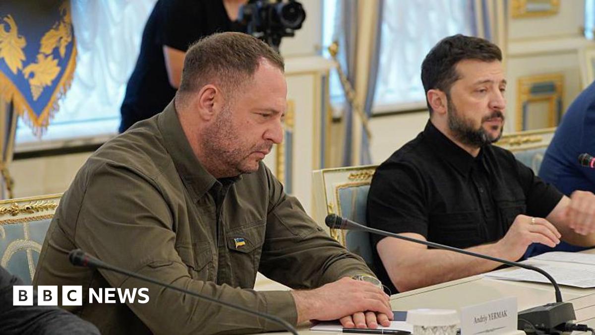 Ukraine's President Volodymyr Zelensky (R) and Head of the Office of the President of Ukraine Andriy Yermak sit at a table