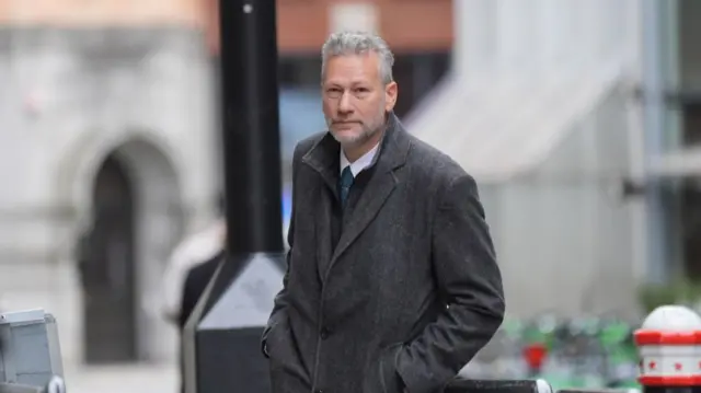 Nathan Gill in a grey wool coat and white shirt outside the Old Bailey